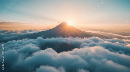 Mountain Peak Illuminated by Sunrise Above a Sea of Clouds