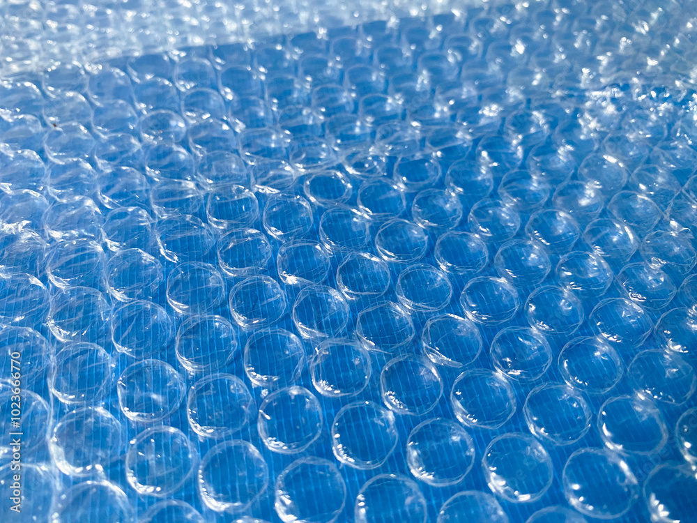 Clear plastic bubble wrap or air bubble packing isolated on blue background. Clear plastic bubble wrap or air bubble packing isolated on blue background.