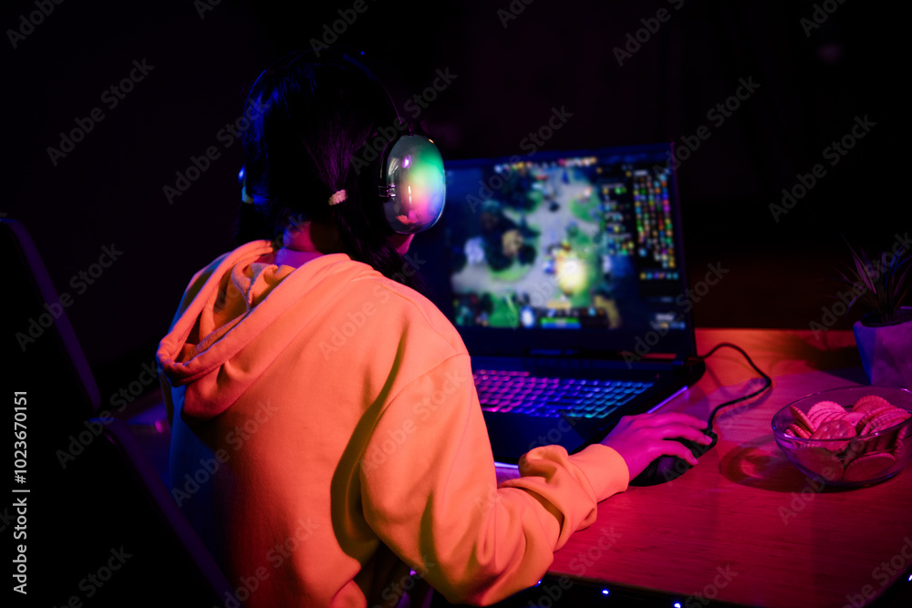 Photo of gamer lovely young lady back view play strategy game gamer laptop late night room indoors Photo of gamer lovely young lady back view play strategy game gamer laptop late night room indoors