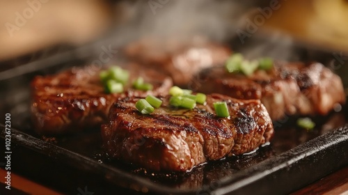 Juicy grilled steak sizzling on a hot plate with green onions