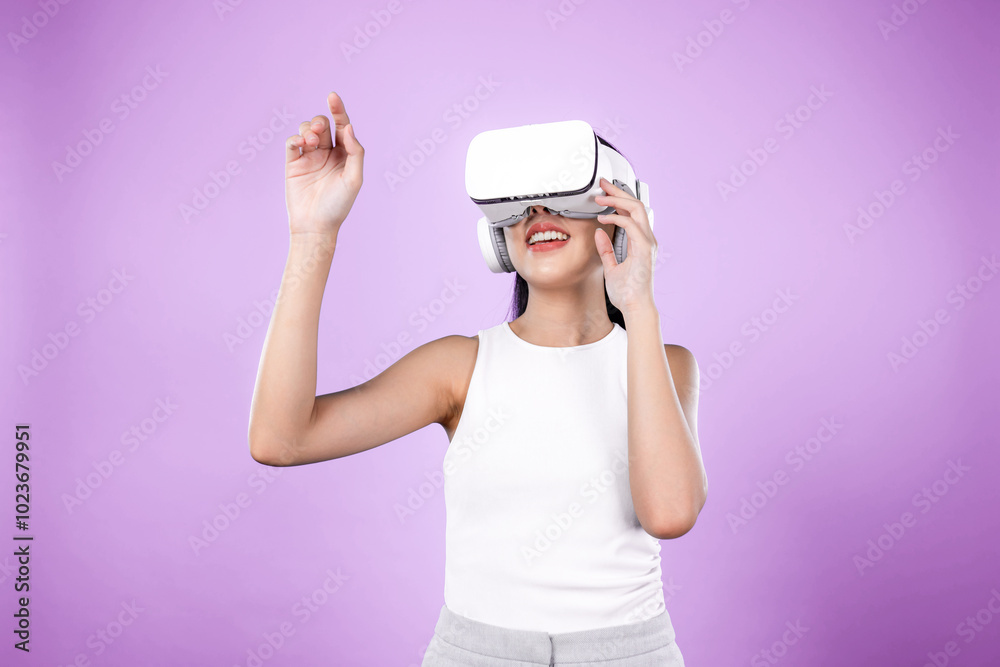 Smart female standing with pink background wearing VR headset connecting metaverse, futuristic cyberspace community technology. Elegant woman excited seeing generated virtual scenery. Hallucination. Smart female standing with pink background wearing VR headset connecting metaverse, futuristic cyberspace community technology. Elegant woman excited seeing generated virtual scenery. Hallucination.