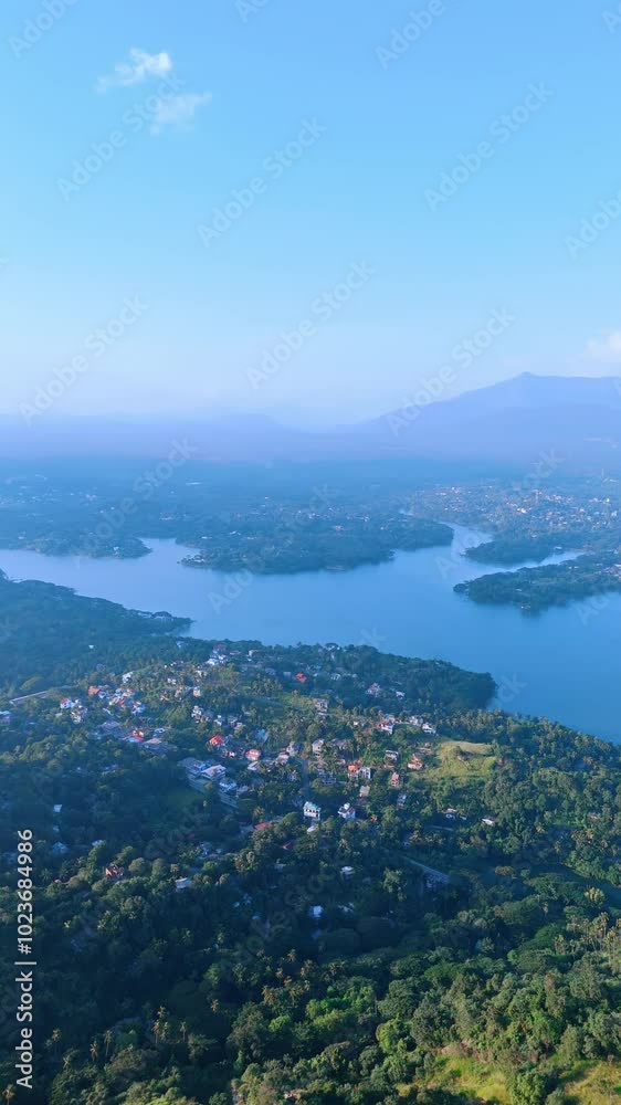 Jaw-dropping scenery of the green panorama of Sri Lanka. Sunny view of inhabited area around the beautiful river. Top view. Vertical video. Jaw-dropping scenery of the green panorama of Sri Lanka. Sunny view of inhabited area around the beautiful river. Top view. Vertical video.