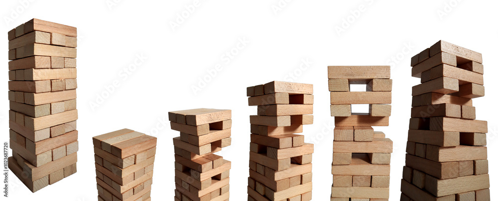 Close-up of a wooden tower made of blocks isolated on a white background. A tower of unevenly shifted wooden beams. Close-up of a wooden tower made of blocks isolated on a white background. A tower of unevenly shifted wooden beams.
