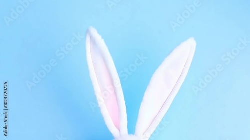 Bunny ears on a light blue background, symbolizing Easter or springtime