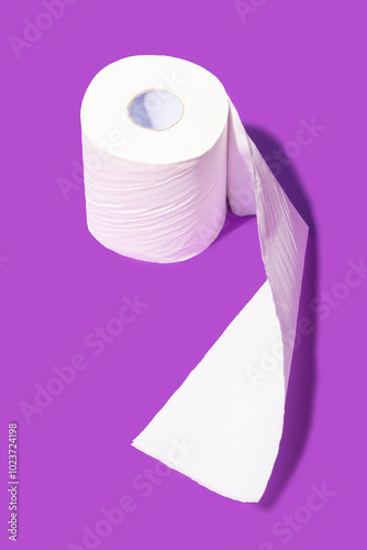Single roll of toilet paper on purple background