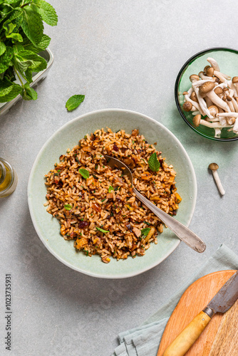 Top view of a brown rice and nuts dish with mushrooms and herbs photo