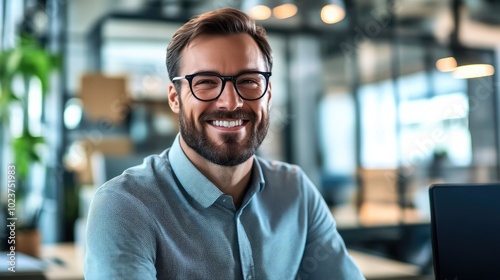 Young Office Worker Analyzing Reports in Modern Office