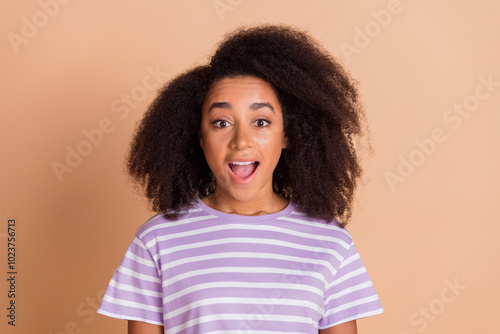 Portrait of pretty young girl open motuh wear striped t-shirt isolated on beige color background photo