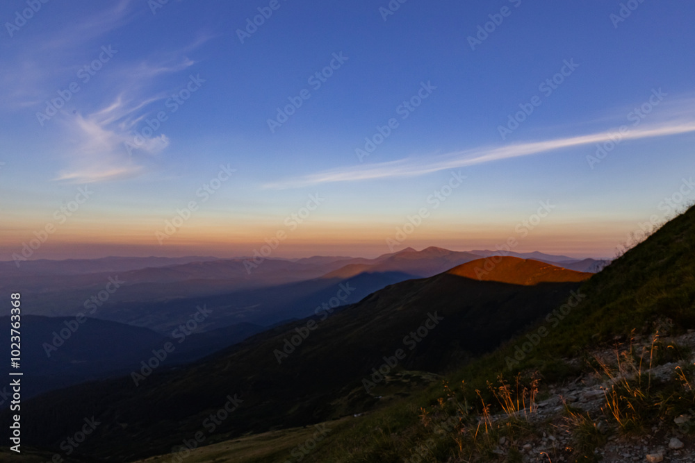 the last rays of the sun before sunset in the mountains, mountain peaks cast shadows on the valleys the last rays of the sun before sunset in the mountains, mountain peaks cast shadows on the valleys