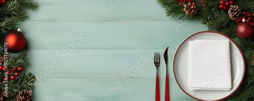 Flat lay of Christmas dinner essentials cutlery, napkins, and festive plates arranged on a green background, elegant holiday dining