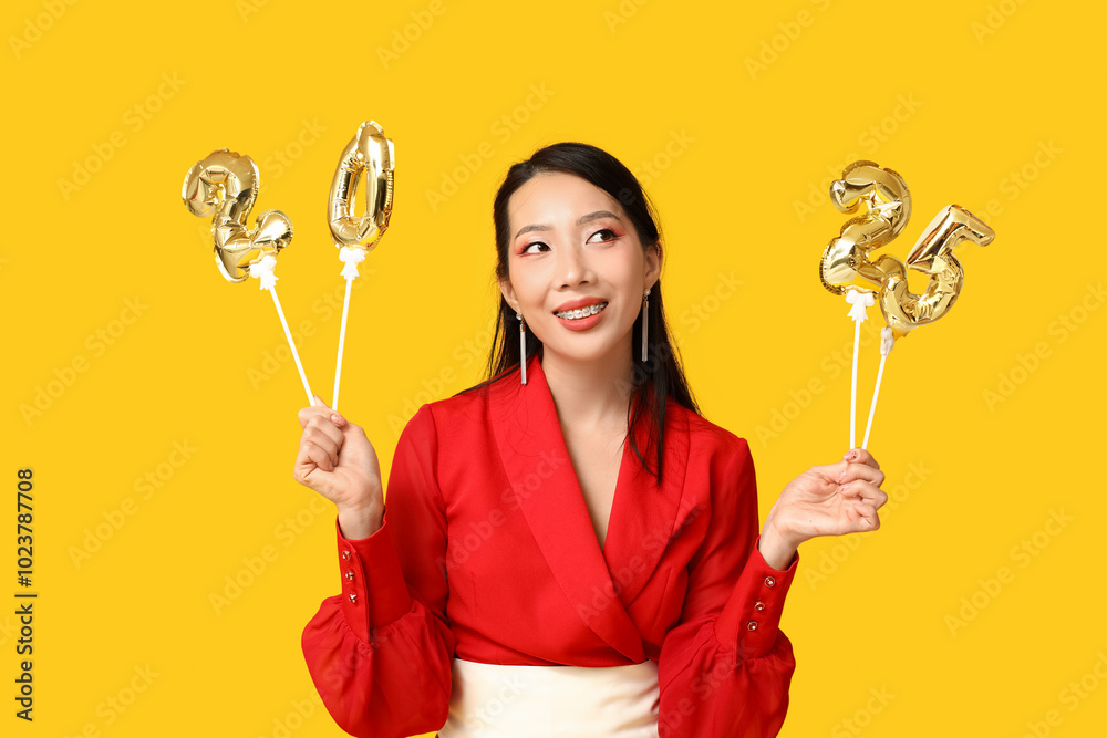 Beautiful young happy Asian woman with figure 2024 made of balloons on yellow background. Chinese New Year celebration Beautiful young happy Asian woman with figure 2024 made of balloons on yellow background. Chinese New Year celebration