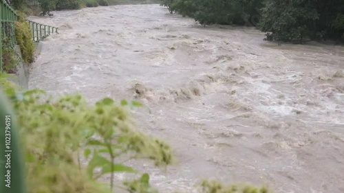 a massive flood transforms a peaceful riverbank in photo