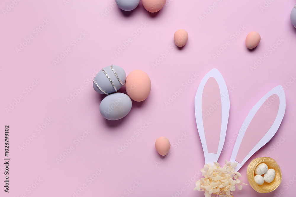 Composition with painted Easter eggs, nest and paper bunny ears on purple background Composition with painted Easter eggs, nest and paper bunny ears on purple background
