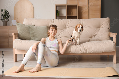 Young woman sitting on yoga...