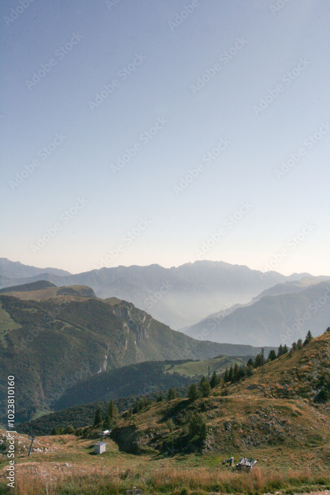 Sunny Italian mountains with low fog and rocks in the foreground, Monte Baldo, Italy Sunny Italian mountains with low fog and rocks in the foreground, Monte Baldo, Italy