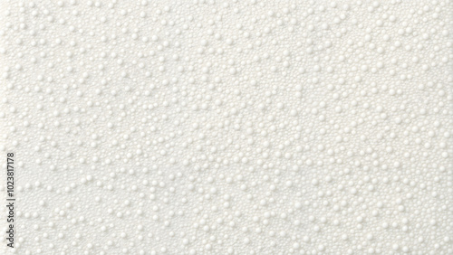 White textured surface with small round beads in a minimalist pattern