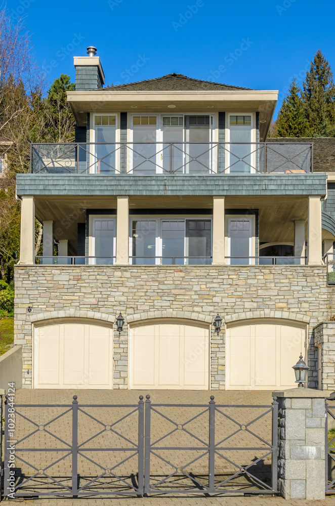 Fragment of a luxury house with a garage door in Vancouver, Canada. Horizontal orientation. Fragment of a luxury house with a garage door in Vancouver, Canada. Horizontal orientation.