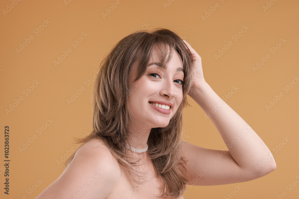 Fototapeta premium Attractive woman with stylish haircut on beige background