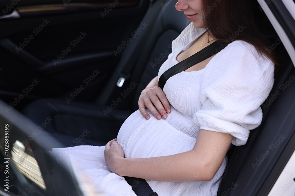Pregnant woman with safety belt in car, closeup Pregnant woman with safety belt in car, closeup