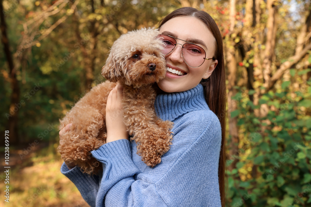Smiling woman with cute dog in autumn park Smiling woman with cute dog in autumn park