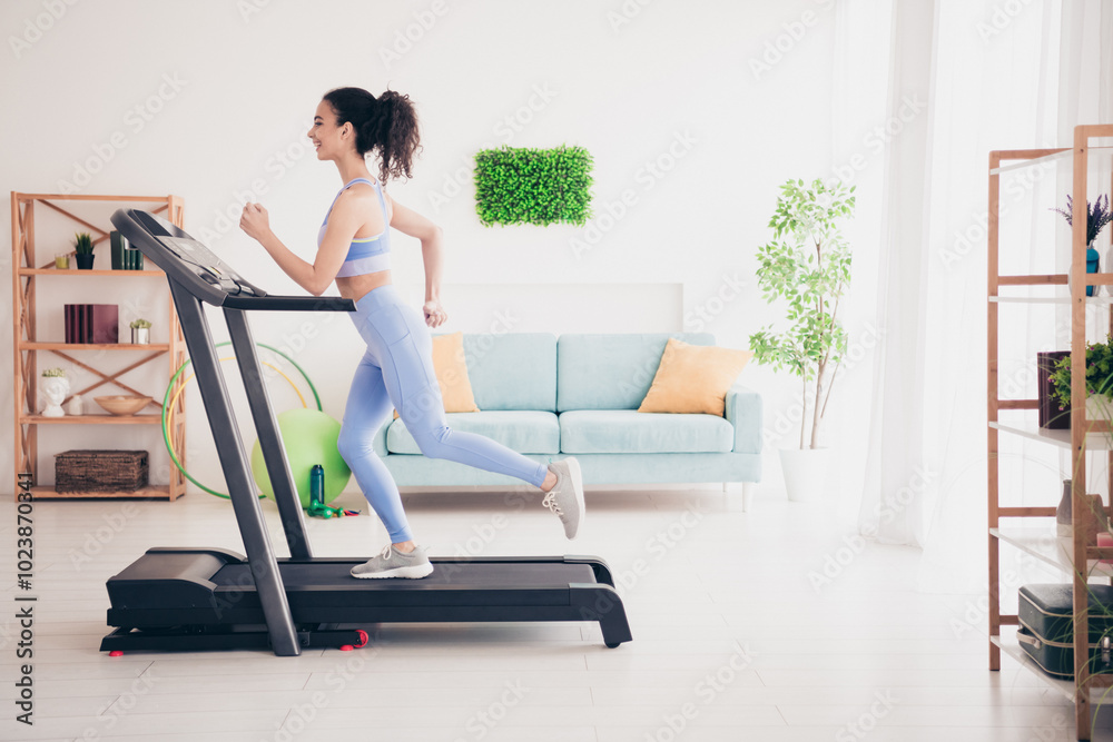 Young woman jogging on a treadmill in a modern home interior, enjoying fitness and healthy lifestyle Young woman jogging on a treadmill in a modern home interior, enjoying fitness and healthy lifestyle