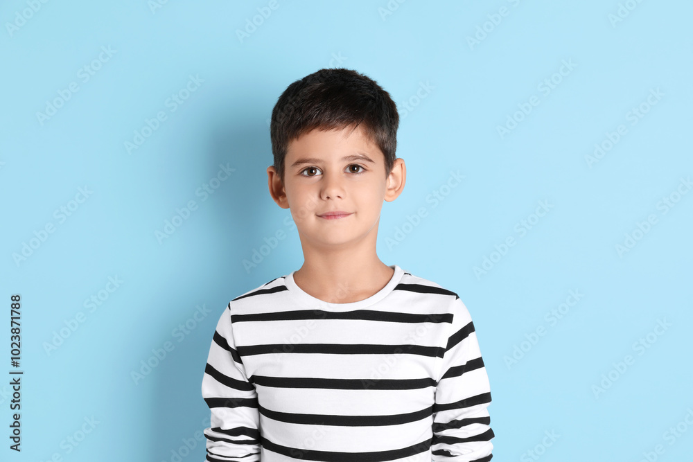 Portrait of cute little boy on light blue background Portrait of cute little boy on light blue background