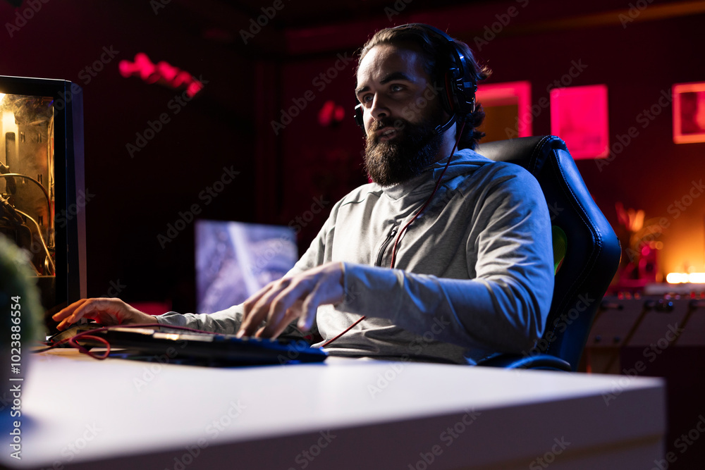 Pro gamer talking with his friends, engaging in online competitive multiplayer tourney using cutting edge gaming system. Man playing videogames with internet teammates, having fun Pro gamer talking with his friends, engaging in online competitive multiplayer tourney using cutting edge gaming system. Man playing videogames with internet teammates, having fun