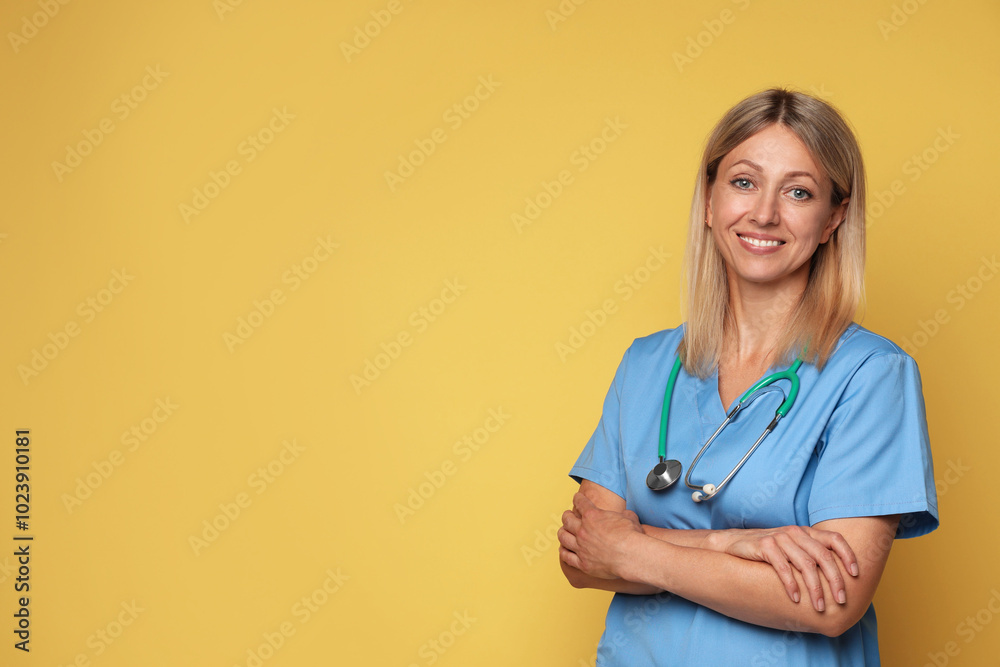 Portrait of nurse in medical uniform with stethoscope on yellow background, space for text Portrait of nurse in medical uniform with stethoscope on yellow background, space for text