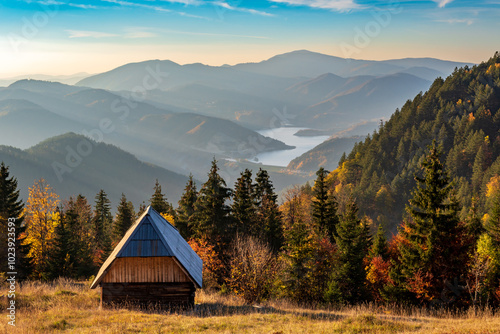 View of a wooden house and lake in autumn