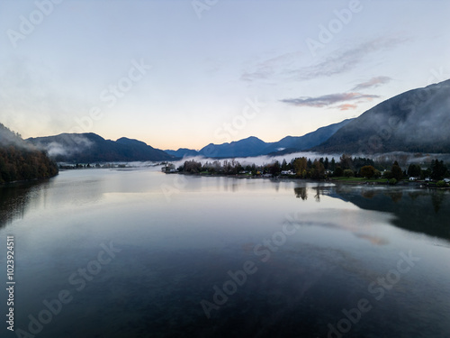 Serene Morning View of Misty Mountain Range and Calm Reflective Lake in Mission, BC, Canada