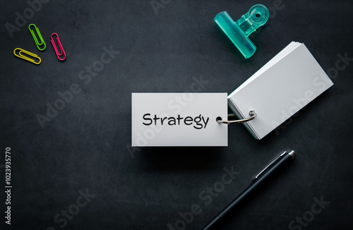 There is word card with the word Strategy. It is as an eye-catching image.