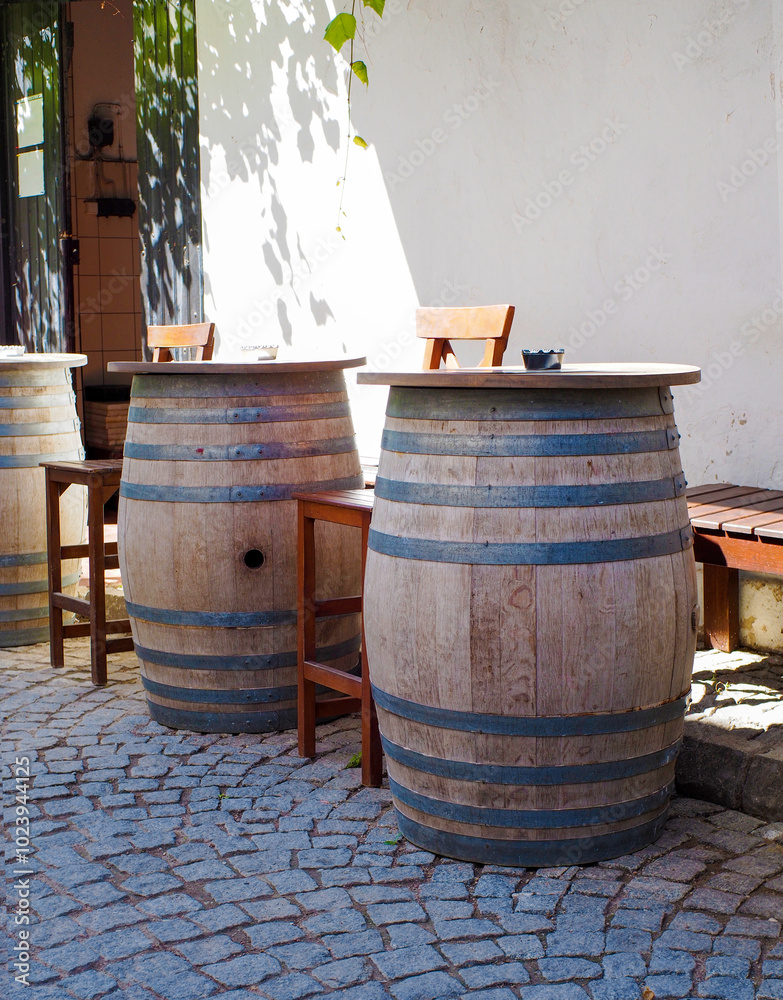 Wooden beer barrels used as tables in the street Wooden beer barrels used as tables in the street