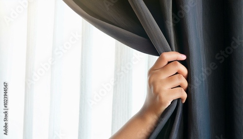 Human hand opening black curtain with white background