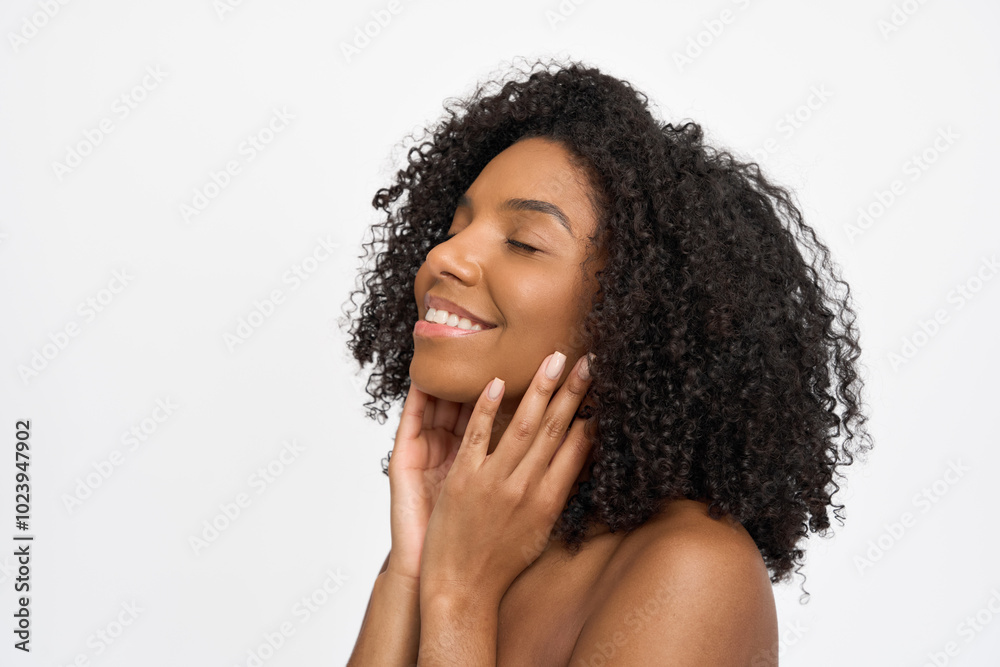 Young happy African American woman model touching pure healthy perfect skin care advertising natural treatment isolated on white background. Skincare facial beauty cosmetic products ads concept. Young happy African American woman model touching pure healthy perfect skin care advertising natural treatment isolated on white background. Skincare facial beauty cosmetic products ads concept.