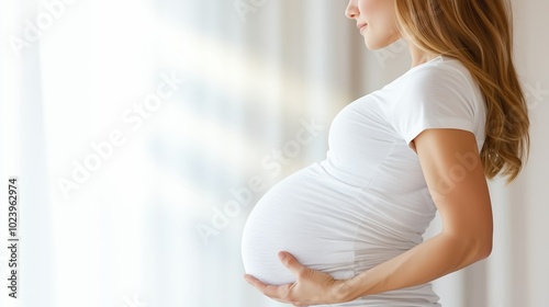 Woman is pregnant and holding her belly. Concept of anticipation and excitement for the upcoming arrival of the baby Free Download Woman is pregnant and holding her belly. Concept of anticipation and excitement for the upcoming arrival of the baby - GFXLoad