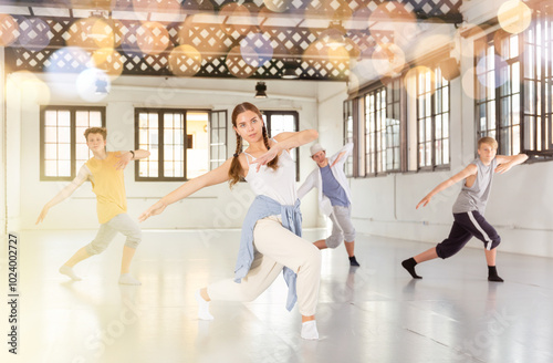 Team of young dancers training street dance moves and having fun