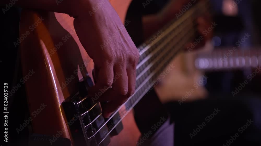 Male fingers playing the bass guitar. Focus selected Male fingers playing the bass guitar. Focus selected