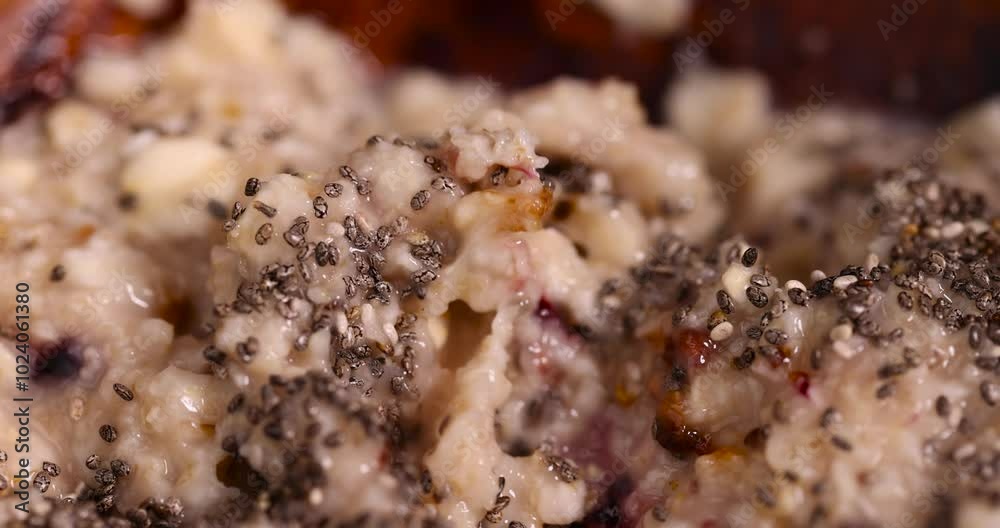 oat flakes with the addition of pieces of dried berries and fruits, oatmeal porridge during cooking for eating oat flakes with the addition of pieces of dried berries and fruits, oatmeal porridge during cooking for eating