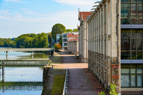 Riverside promenade along the banks of the Marne river at the ancient Menier Chocolate Factory in Noisiel, Paris Region, France photo