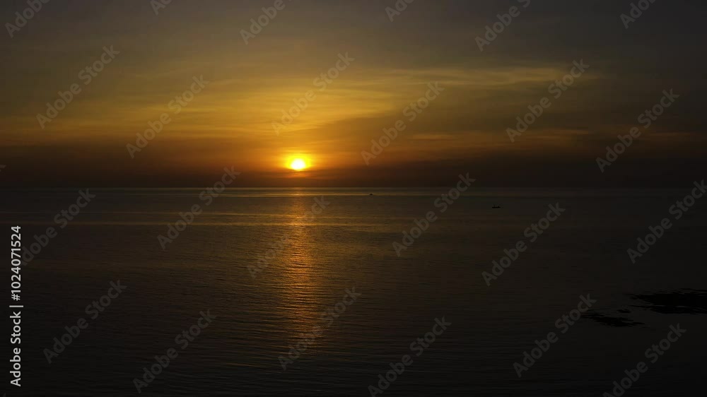 Red orange sunset sky over the sea. Beautiful scenery of sunset in Bantayan Island. Madridejos, Cebu. Philippines. Red orange sunset sky over the sea. Beautiful scenery of sunset in Bantayan Island. Madridejos, Cebu. Philippines.