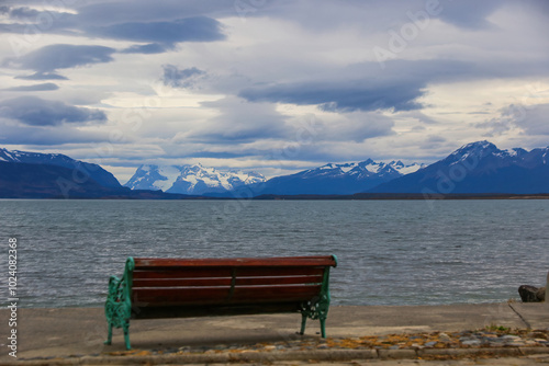 Bench facing the Admiral Montt Gulf on the waterfront of Puerto Natales, Patagonia, Chile, Magallanes and Antartica Chilena Region photo