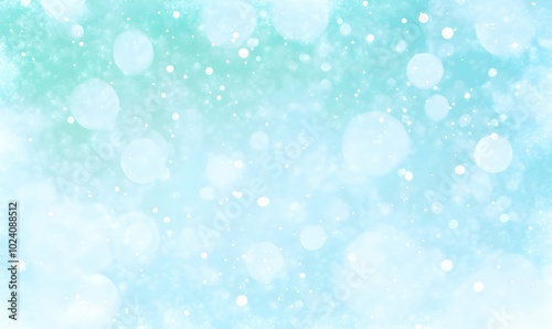 Abstract light blue and white bokeh background with soft glow and blur effect.