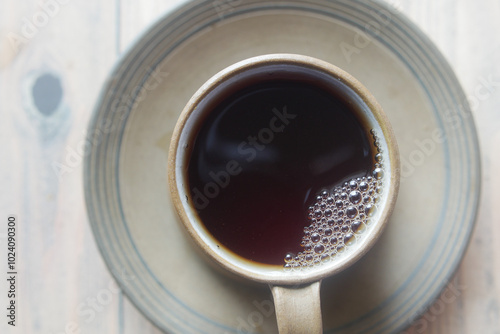 A Stunning Top View of a Cup of Hot Black Coffee Sitting Beautifully on a Saucer