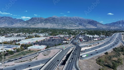 Aerial American Fork Utah highway intersection traffic 2. Central Utah city. Economic center for residential  retail shopping. I-15 Interstate Freeway. Growing population, homes, business and schools.
