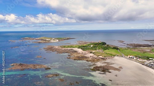 Guernsey. Flight towards Lihou Island on west coast of Island at half tide showing causeway and the crystal clear waters of this RAMSAR site on bright sunny day photo