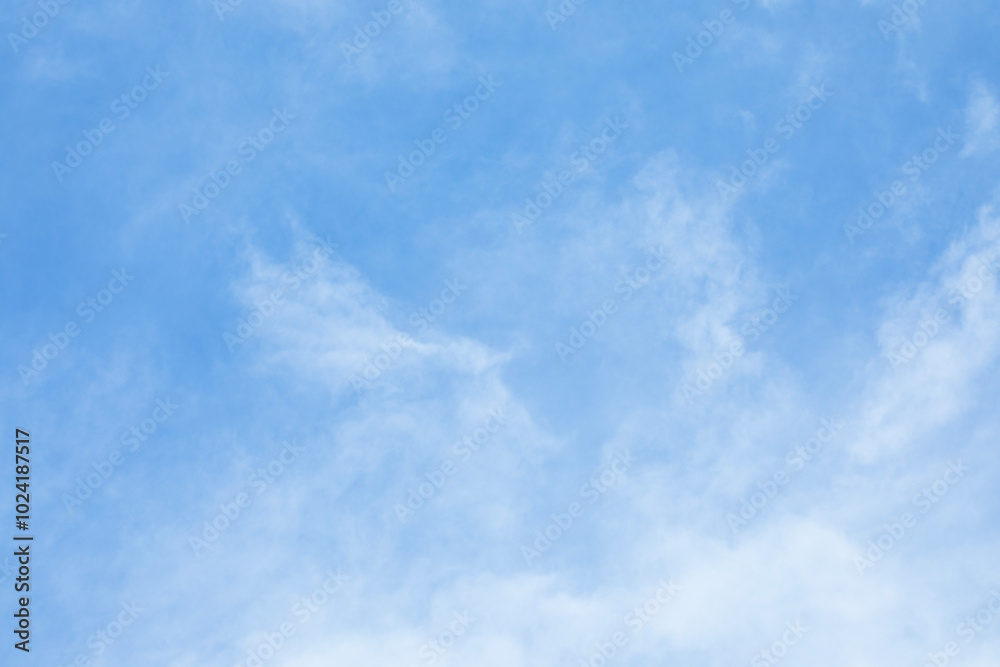 Blue sky background and white clouds soft focus, and copy space horizontal shape.