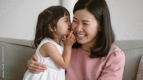 Joyful moment between a mother and daughter, natural affection, indoor setting.