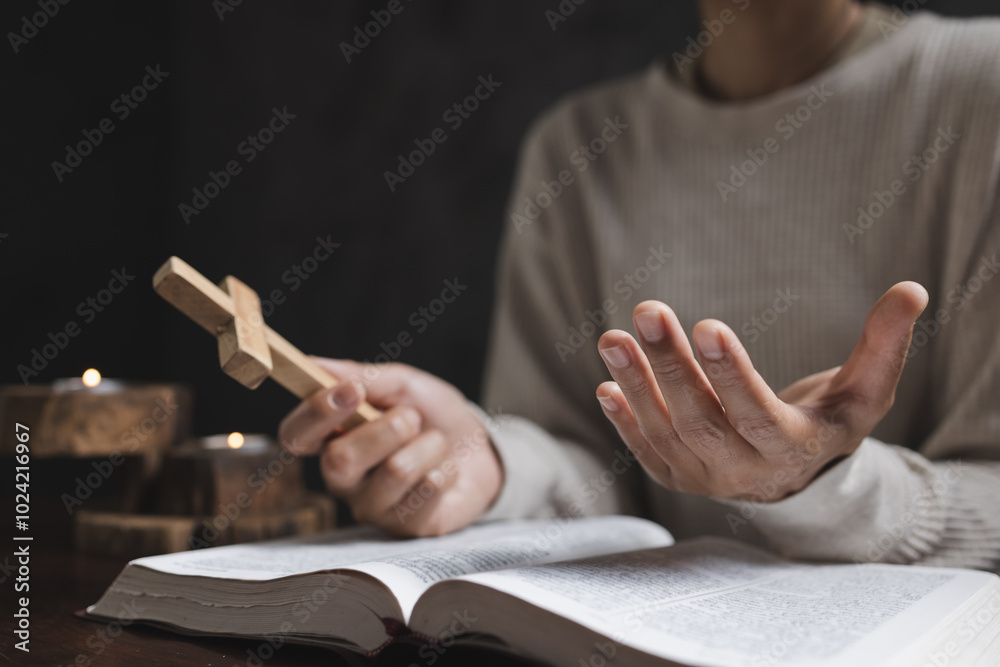 Fototapeta premium A woman prays with a Bible in a room. her faith unwavering as she prayed and worshiped God, religion concept.
