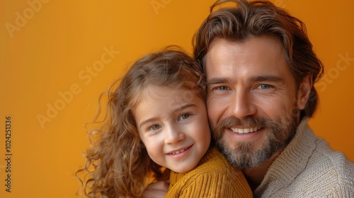 A heartwarming portrait of a father and daughter smiling together against a warm orange background, symbolizing family love and connection