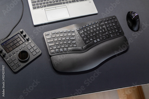 Ergonomic keyboard and ergonomic mouse as ergonomic home office equipment for freelance work and healthy workplace for notebook and clean desktop for efficient work from home for video editing graphic